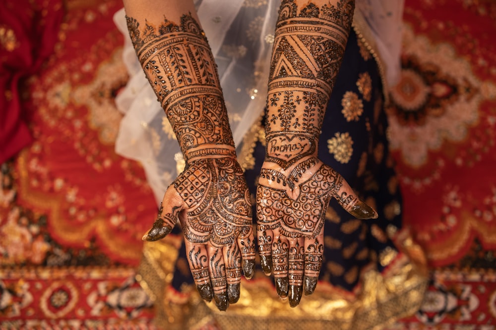 Bridal mehndi against a navy lehenga